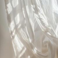 Elegant white curtains gently billowing in the soft breeze. photo