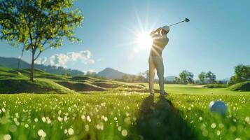 A golfer teeing off on a beautiful golf course on a sunny day. photo