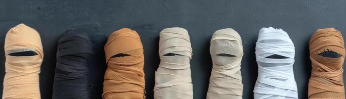 Assorted mummy wrappings, spooky Halloween backdrop, editorial shot, empty copy space for text on side photo