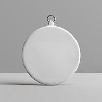 A white circle with a metal loop at the top for hanging. photo