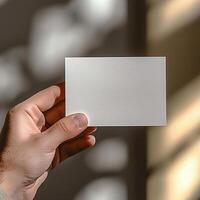 a hand model holding a 5 x 7 inch card, mockup style photo