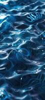 beautiful blue water surface with small waves. The water is crystal clear and reflects the light blue sky. photo