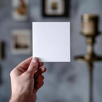 a photo of hand holding a postcard the postcards orientation is vertical and blank