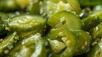 A close up of a plate of thinly sliced cucumbers in a sesame oil and vinegar dressing. photo