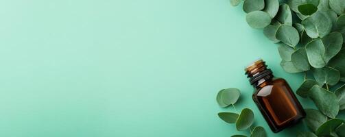 A minimalist composition featuring an amber bottle surrounded by fresh green leaves on a soothing mint background. photo