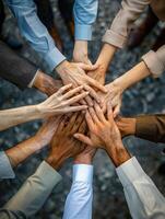 A group of diverse people joining their hands together. photo