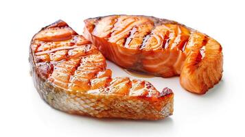 Two pieces of grilled salmon fillet on white background photo