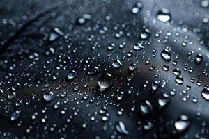 Black fabric with water drops photo