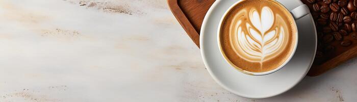 White cup of coffee with beautiful latte art on white marble background. photo