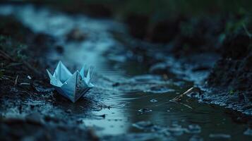 beautiful and unique origami boat floating on a small stream of water photo