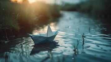 beautiful origami boat floating on a small river photo