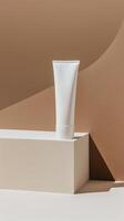 A white tube of face cream on a podium against a brown background. photo