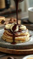Decadent chocolate syrupPu Bu ing over a stack of pancakes topped with banana slices. photo