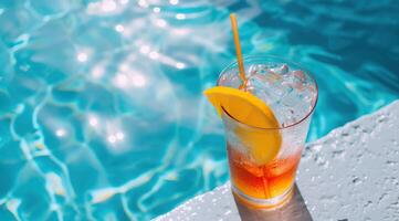 Refreshing summer cocktail with orange slice by the pool photo