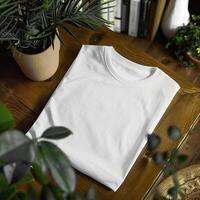Simple white t-shirt on a wooden table surrounded by indoor plants and books, representing minimalistic and eco-friendly lifestyle. photo