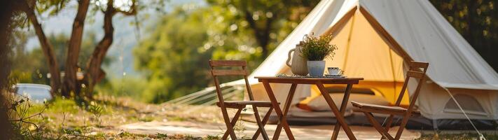 Cozy glamping setup with a canvas tent and wooden furniture in a peaceful forest setting, perfect for a relaxing nature getaway. photo