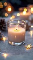 Blank clear straight candle glass on a concrete surface with minimalistic star decorations and soft fairy lights, modern minimalist Christmas mockup, industrial chic photo