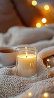 Blank clear straight candle glass amidst a setting with a plush pillow, a scented diffuser, and delicate string lights, modern warm bedroom mockup, serene and stylish photo