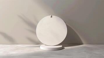 Minimalist round white pedestal for product display with natural light and shadow effects on a plain background. photo