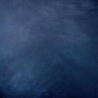 Dark blue grunge textured background, ideal for design projects, backdrops, and creative applications with a moody, vintage feel. photo