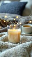 Blank clear straight candle glass amidst a setting with a plush pillow, a scented diffuser, and delicate string lights, modern warm bedroom mockup, serene and stylish photo