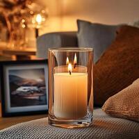 Blank clear straight candle glass amidst a setting with a plush pillow, a scented diffuser, and delicate string lights, modern warm bedroom mockup, serene and stylish photo