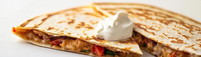 Delicious quesadilla filled with chicken, cheese, and vegetables, served with a dollop of sour cream on a clean background. photo