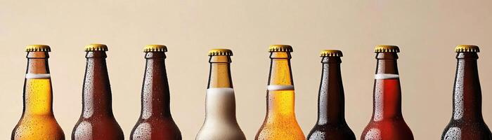 1 An artistic arrangement of several craft beer bottles, varying heights and colors, set against a uniform, lightcolored background, broad negative space for text photo