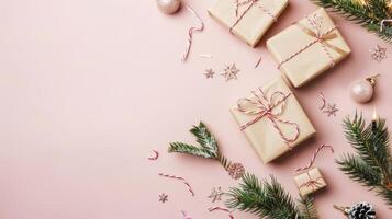 Christmas gifts wrapped in brown paper with candy canes, pine branches, and glitterdecorations on a pink background. photo