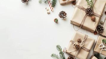 Christmas gifts wrapped in brown paper with pinecones, candy canes, and fir branches on a white background. photo