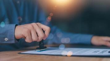 The concept of confirmation of a contract document or a warranty card ,Business Agreements and Approvals ,business contract signing ,Approval of checklist documents ,stamping in the contract photo