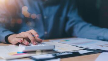 statistical analyst using calculator to calculate and read reports, graphs and charts, business statistics ,Analysis and improvement of corporate strategy ,Statistics and Data Concepts photo