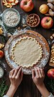 Hands rolling dough for apple pie, surrounded by ingredients. Fall season, cooking. Vertical banner photo