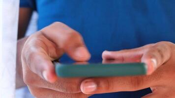 Close up of young man hand using smart phone. video