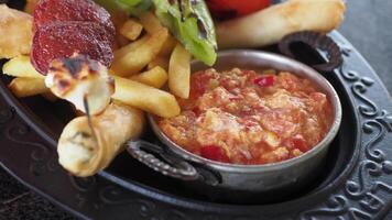 Delicious appetizer platter with fries, dip, and grilled vegetables, great for sharing and snacking video