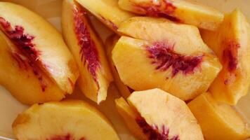 Enjoy the delicious and fresh peach slices that are perfectly prepared and ready to eat now video