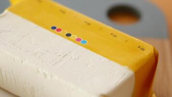 slice of a butter on a paper on table video