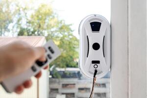 Remote control of a robotic window washer that washes glass from dirt and stains. photo