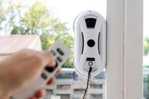 Remote control of a robotic window washer that washes glass from dirt and stains. photo