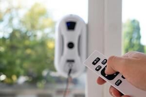 Remote control of a robotic window washer that washes glass from dirt and stains. photo