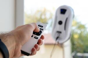 Remote control of a robotic window washer that washes glass from dirt and stains. photo