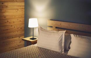 Night scene in cozy room, nightstand with lamp photo