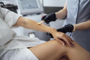 Preparation of clients hand before laser hair removal procedure in spa salon photo