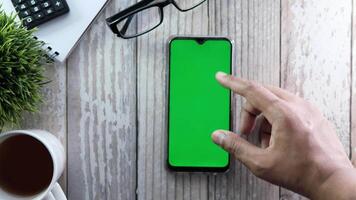 top view of man hand using smart phone on office desk video