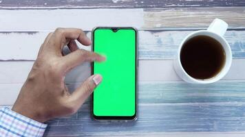 top view of man hand using smart phone on office desk video