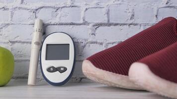 diabetic measurement tools, shoe and apple on table video