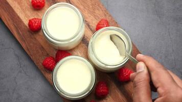 fresh yogurt in a bowl on table . video