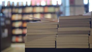 A lot of books are on the shelf in a public library or bookstore video