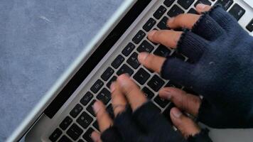 hacker hand stealing data from laptop top down video