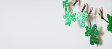 Happy St. Patricks day background with Green glitter shamrocks decoration, banner format photo